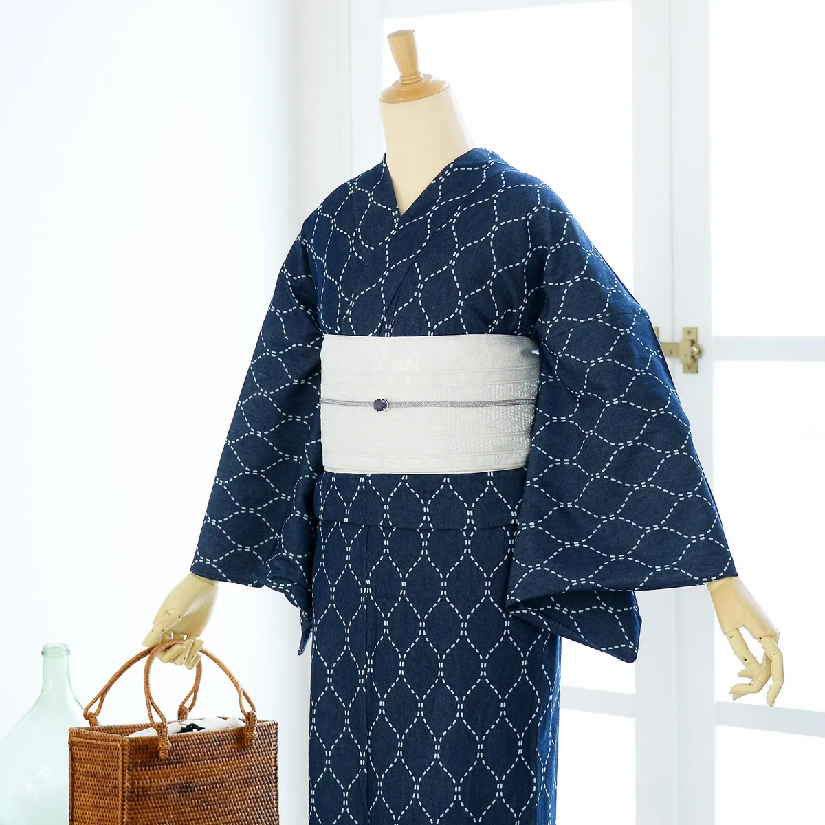 A denim kimono, navy with a white dashed pattern, paired with a white obi on a dress form