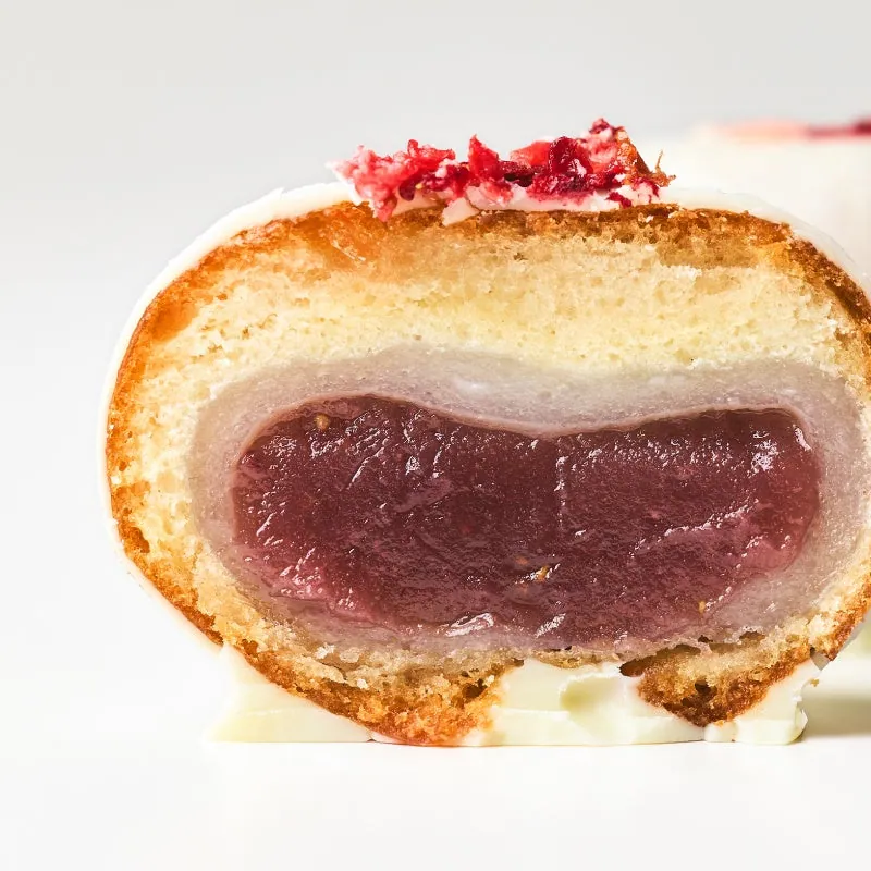 Cross-section of a Kaminari Donut with Benihoppe strawberry paste, white mochi and a white chocolate coating
