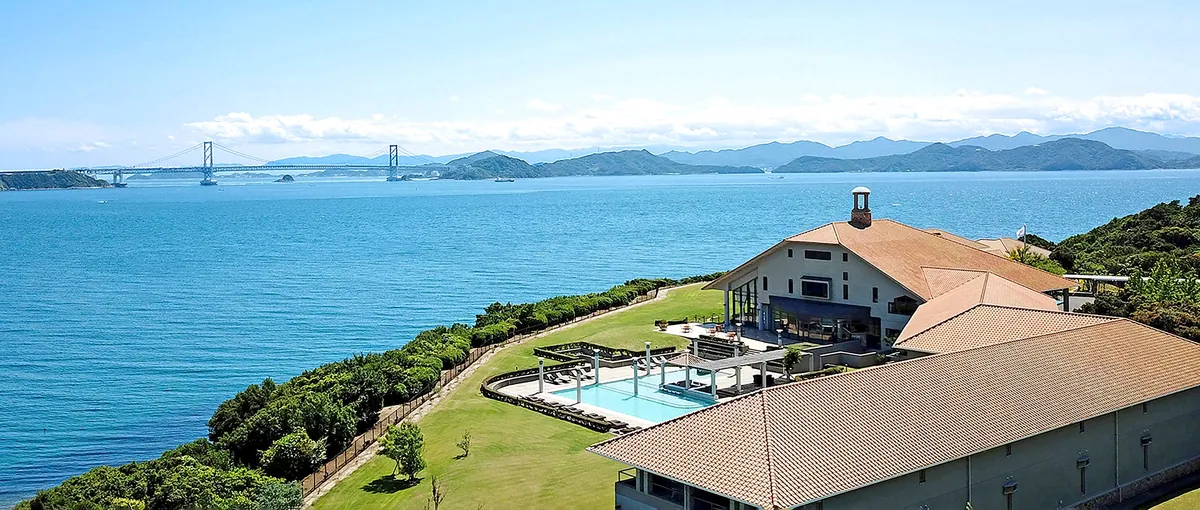 Hotel Anaga on a hill facing the sea, with the Onaruto Bridge in the distance