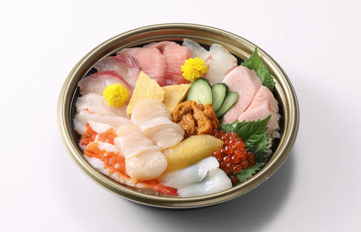 A seafood bowl topped with sea urchin, salmon roe and scallops