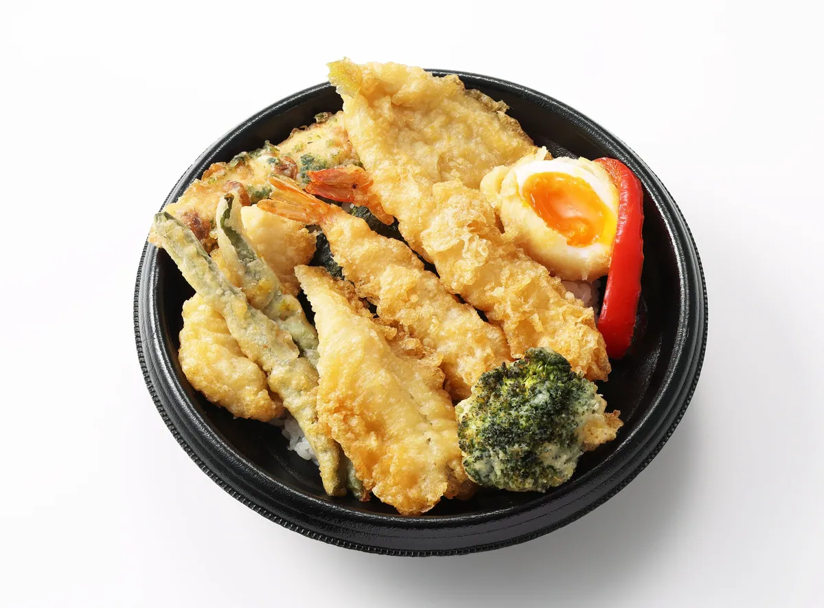 A tempura bowl topped with eight kinds of tempura and a soft-boiled egg